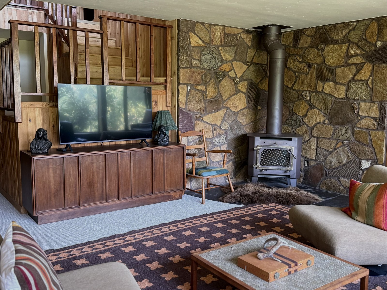 Wood stove and stone wall in the den