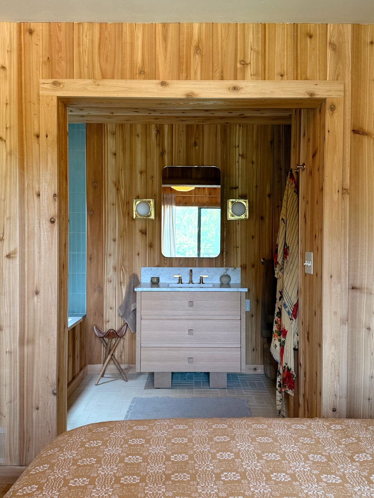 Primary bathroom vanity seen from the bedroom